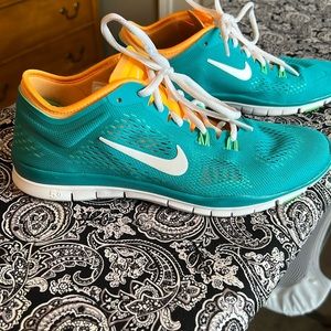 Teal and orange Nike tennis shoes